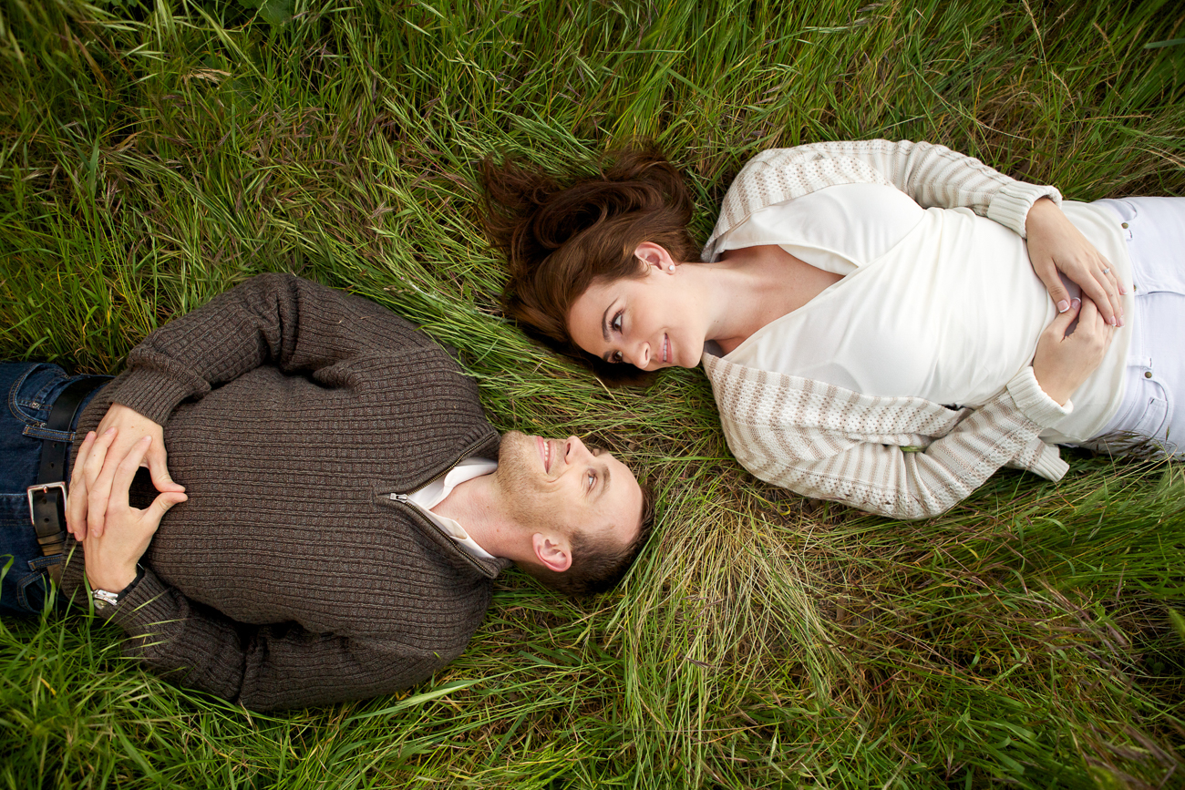 a couple lying together in the tall grass