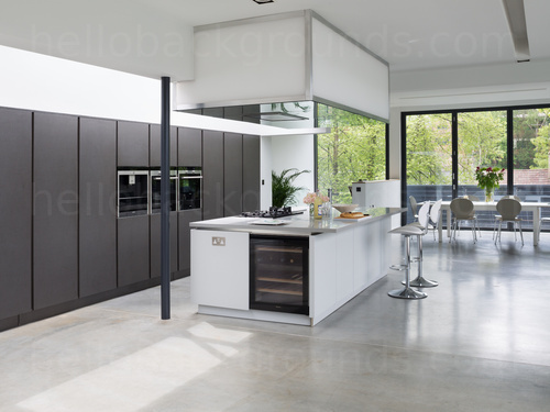 Open modern kitchen featuring kitchen island and stools with dining table next to large window in background  Google Meet background