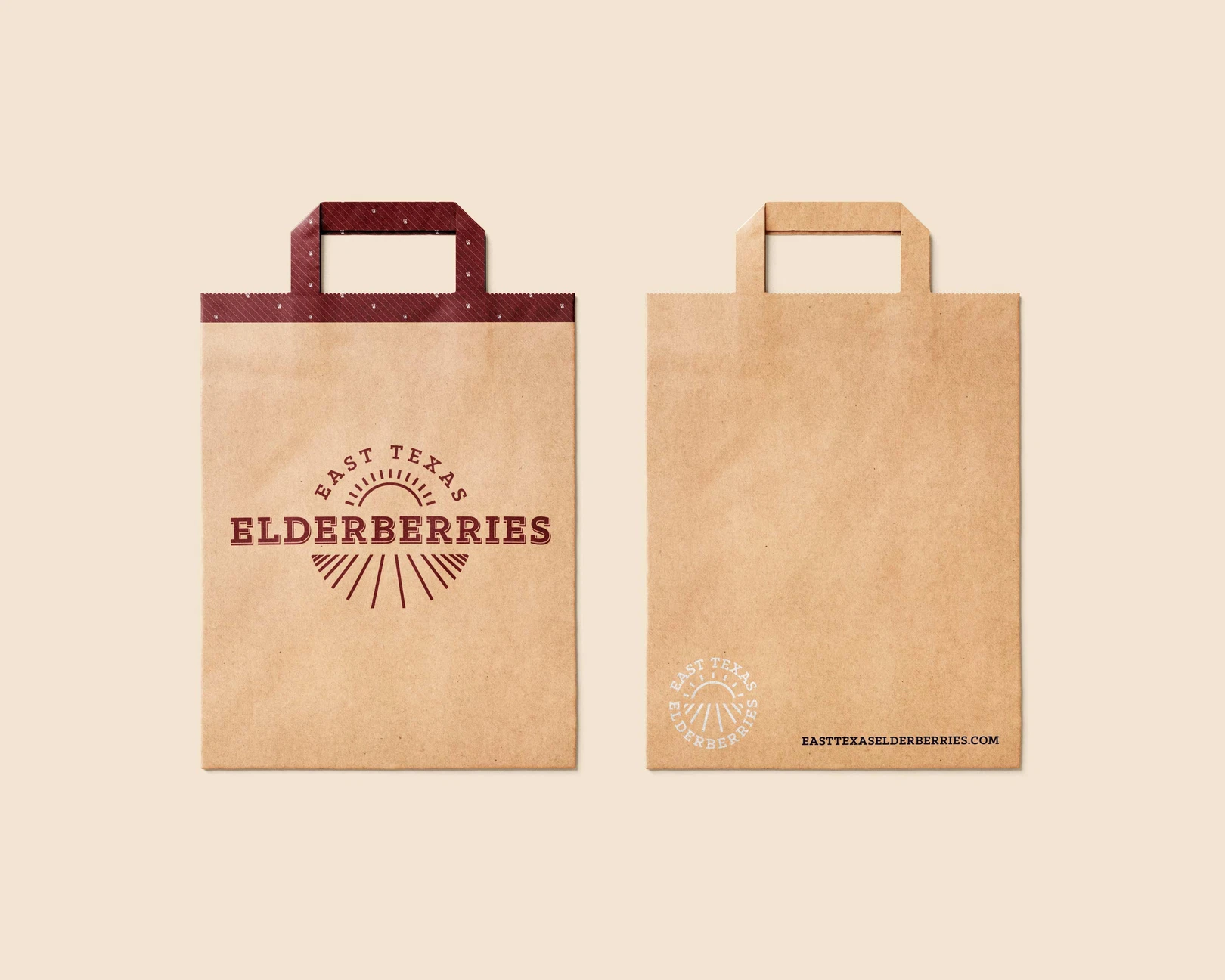 Two shopping paper bags, branded with the The East Texas Elderberries identity