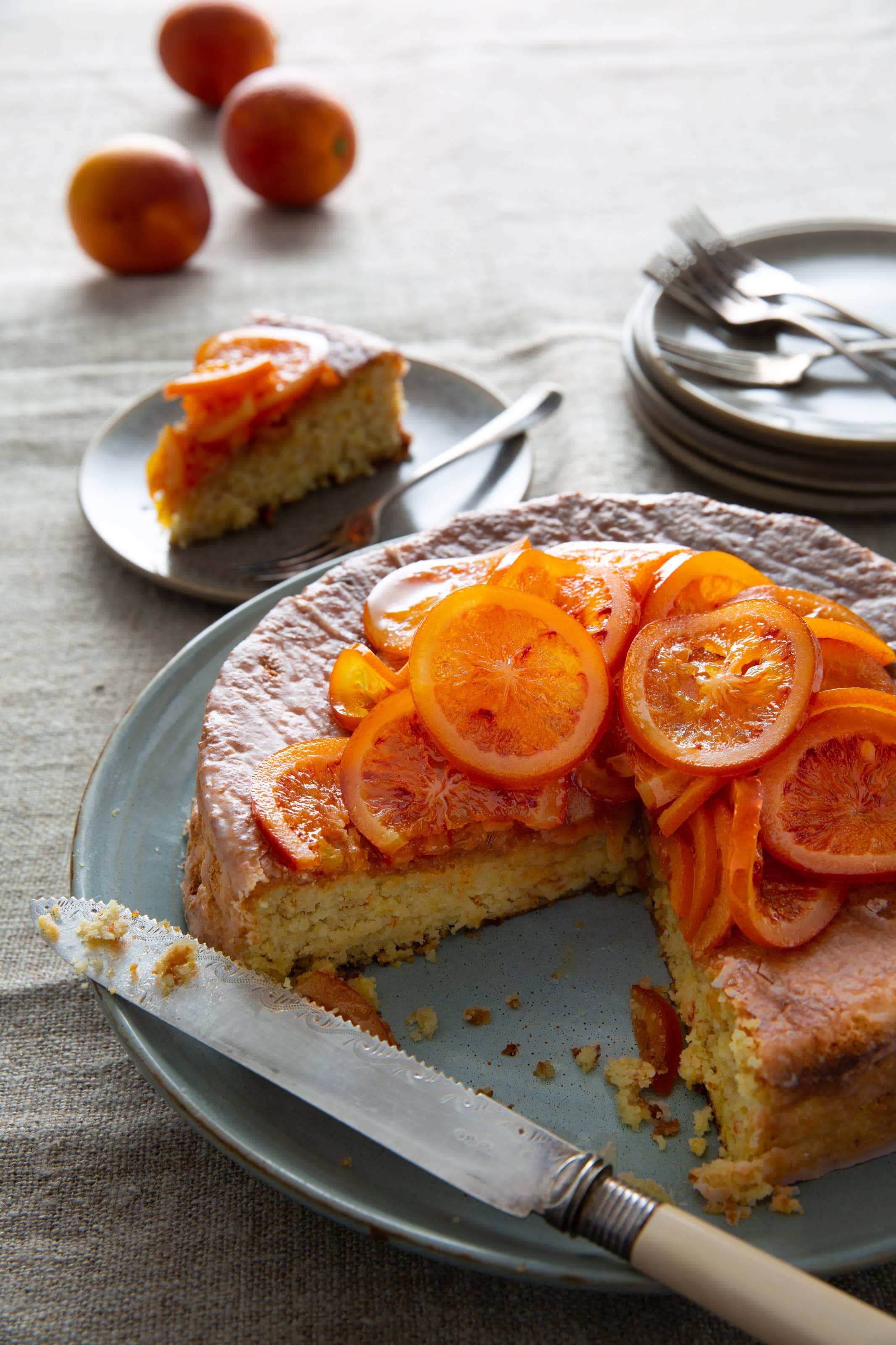 almond and blood orange cake with candies blood oranges on top.