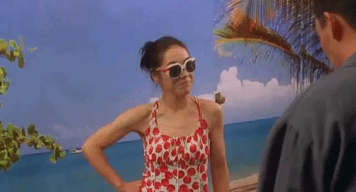 An animated gif of a scene from the film 'Breath' of Yeon dancing in sunglasses and summer clothes for Jeon. The walls are painted to resemble the beach.