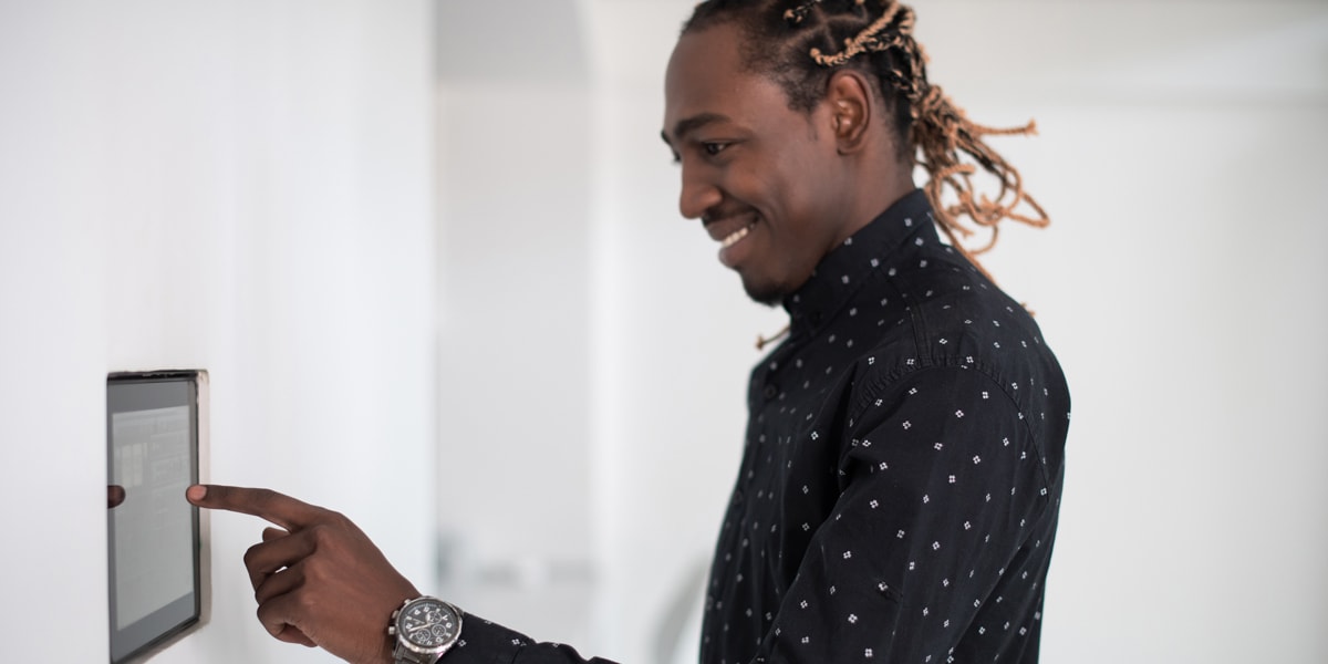 What are the biggest trends in tech right now? A UX designer interacting with a touchscreen device A UX designer smiling and touching a screen