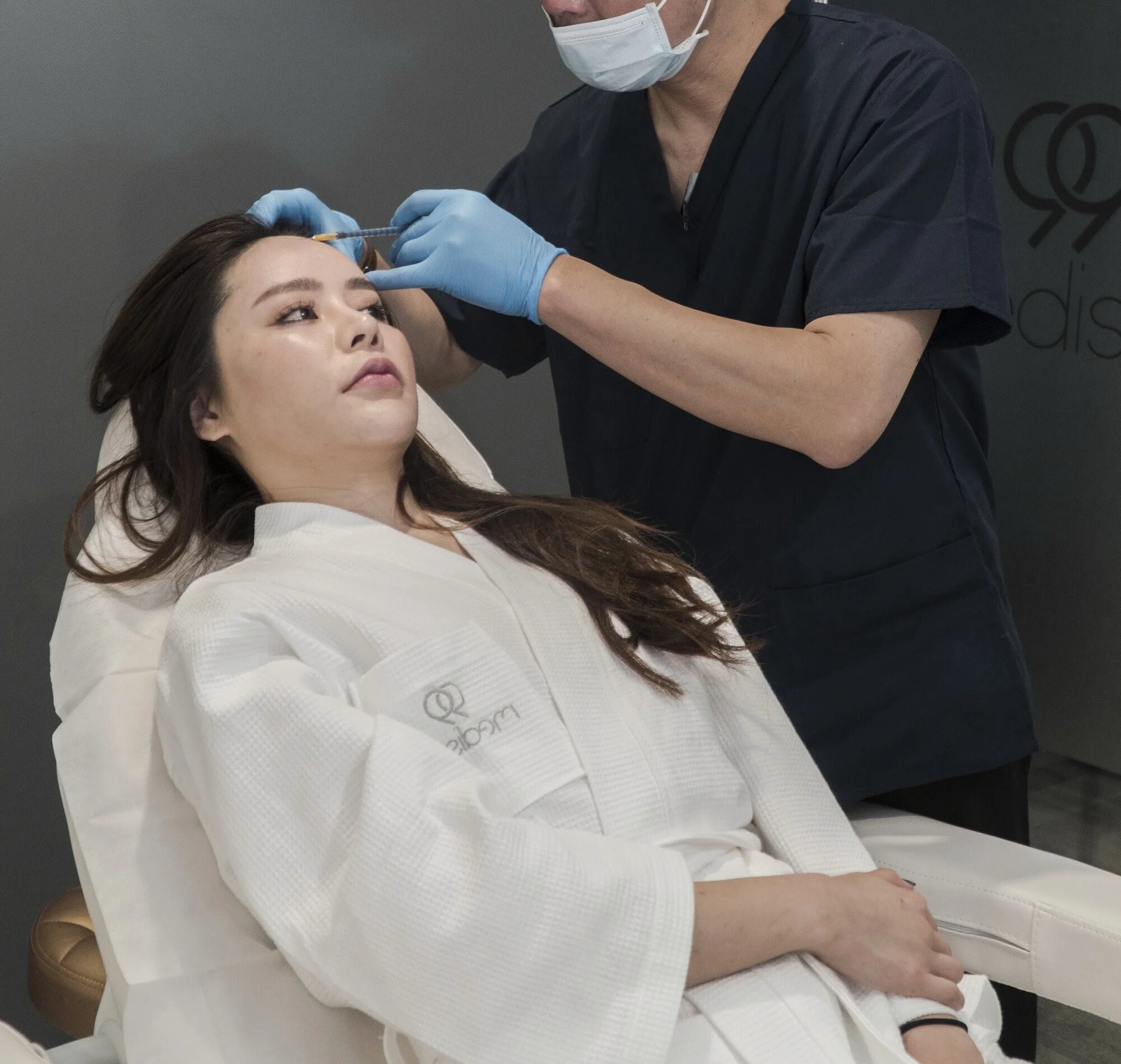 Female patient receiving injection to her face