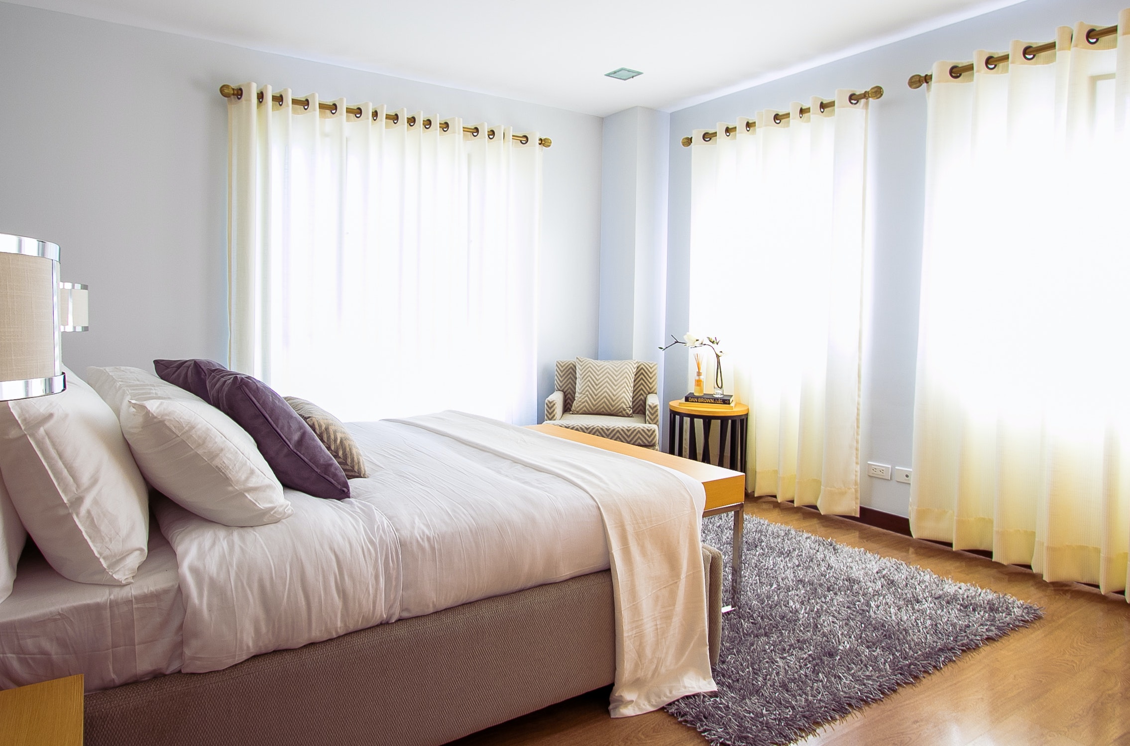 a bedroom with white drapes