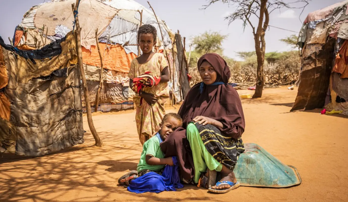 Nimco with two of her children outside the family home in Somaliland.