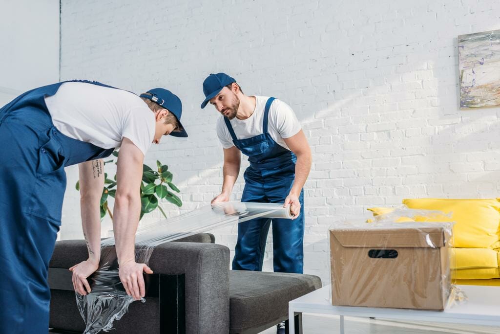 movers wrapping couch roll for furniture moving