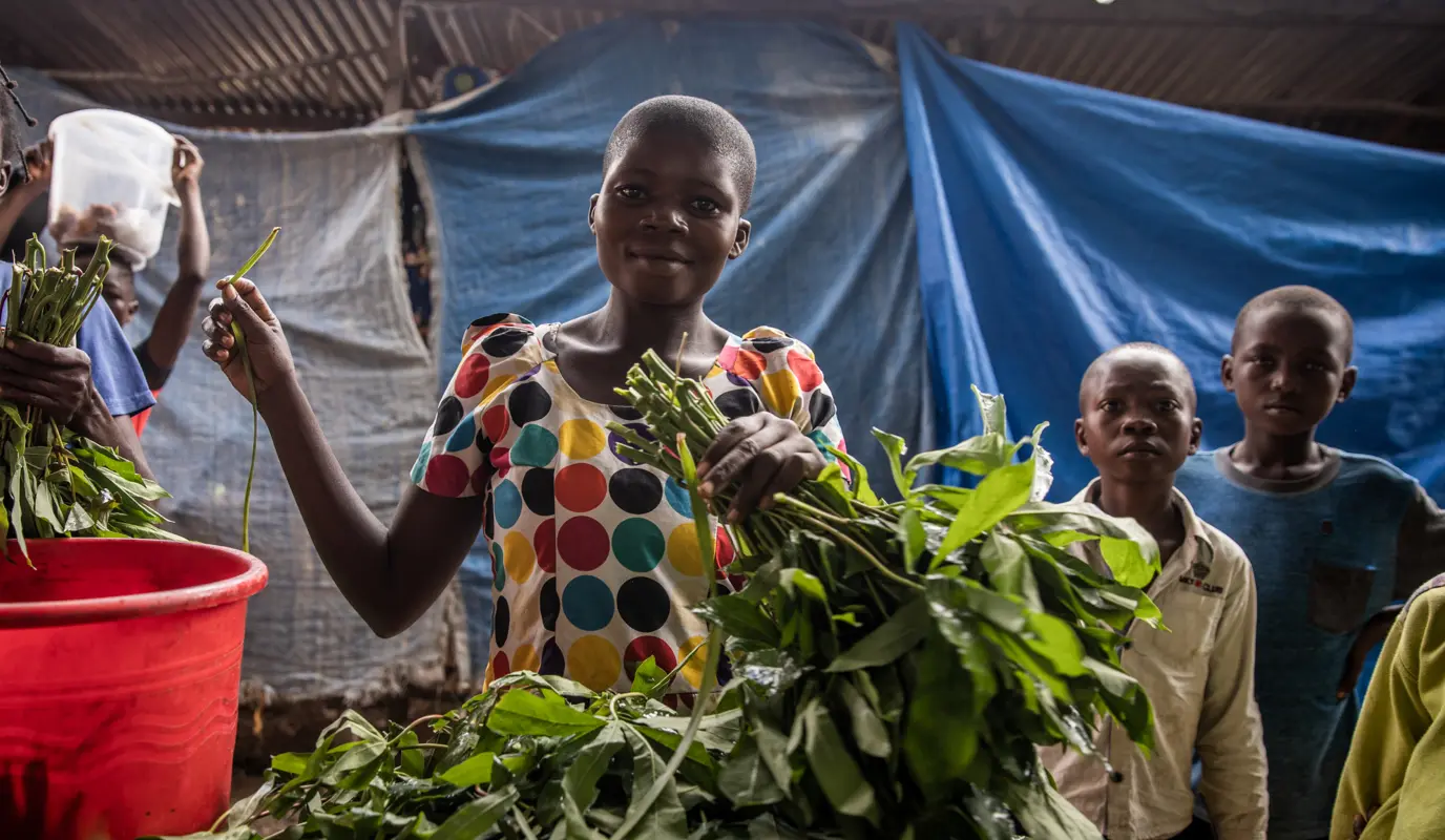 Woman and her vegetables for sale at the central market of the town of Manono, Tanganyika Province.
