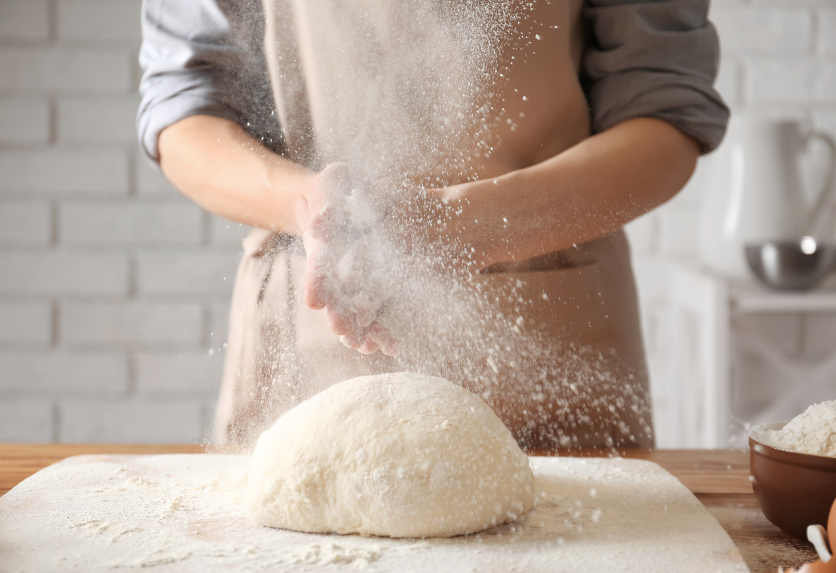 baker dusting hands
