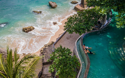Infinity pool overlooking a scenic beach.