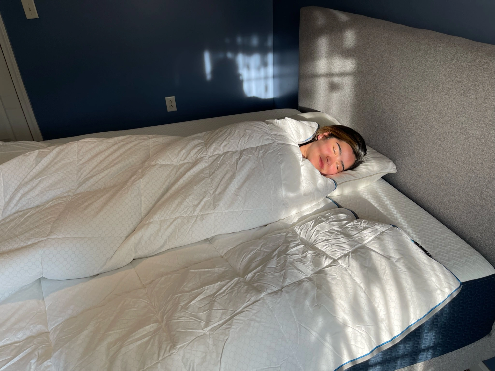 Our reviewer taking a nap with the Hush microgravity duvet in our studio
