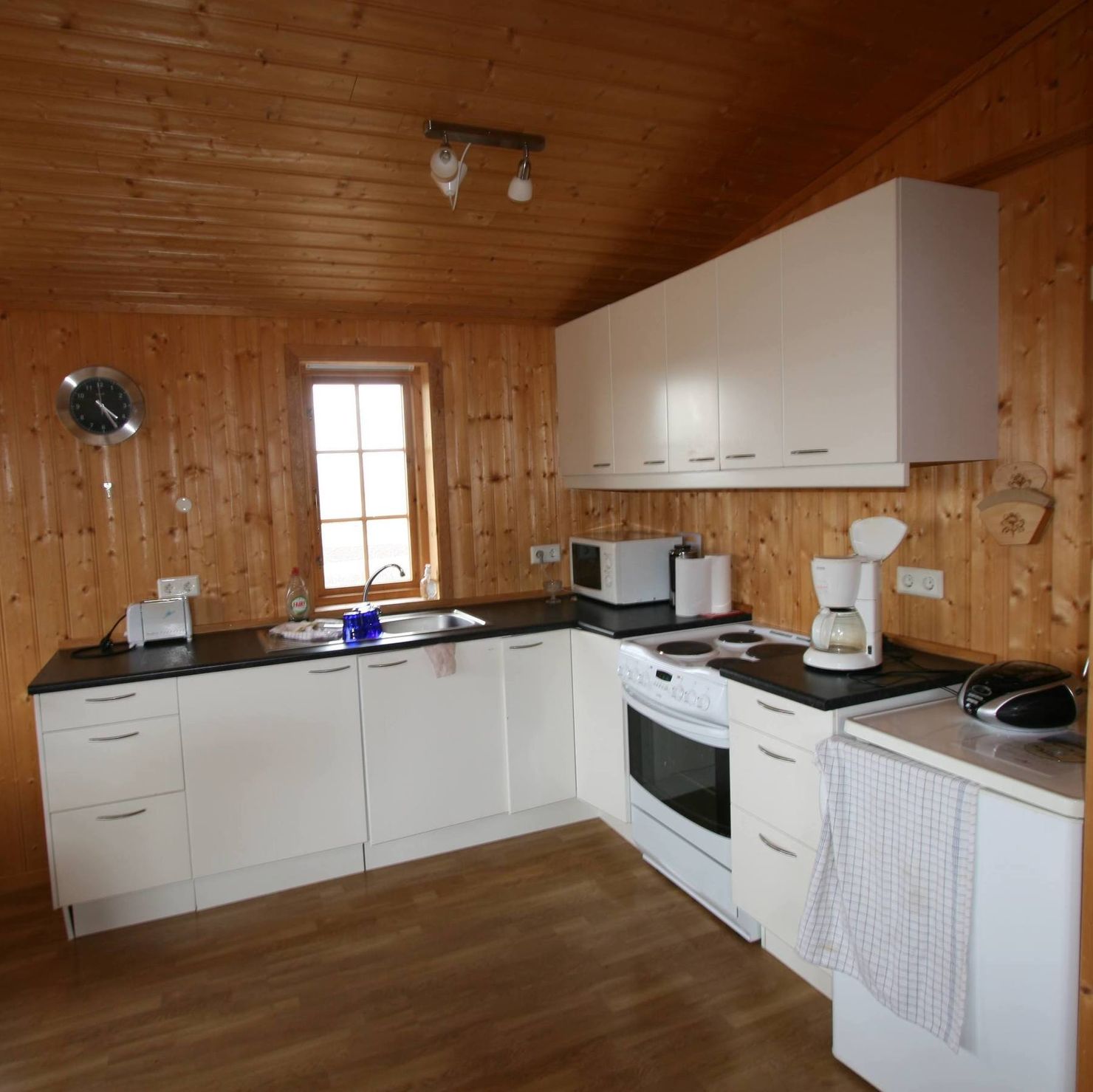 Large kitchen with toaster, refrigerator and cooker