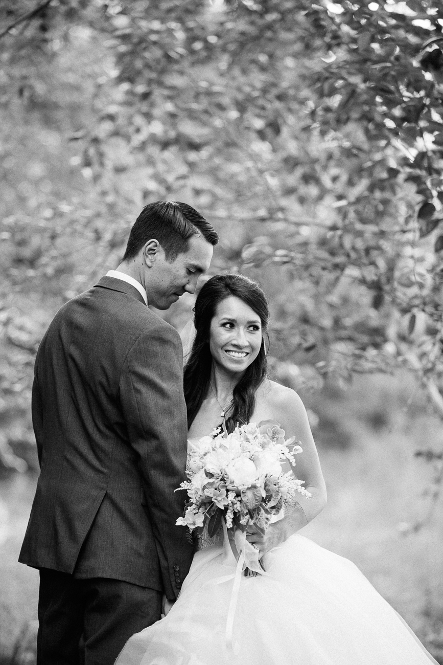a monochrome image of a bride and groom embracing