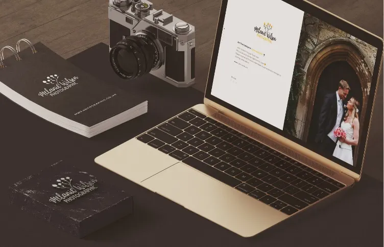 M. Wilson Photography - Mockup with laptop and stationery.