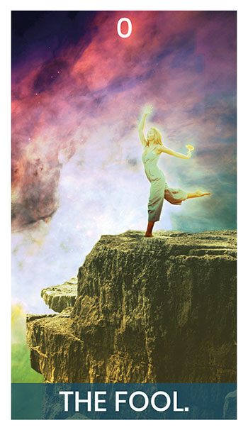 The Fool card. A woman dancing on a golden cliff. She holds a flower in her hand, with the universe at her side.