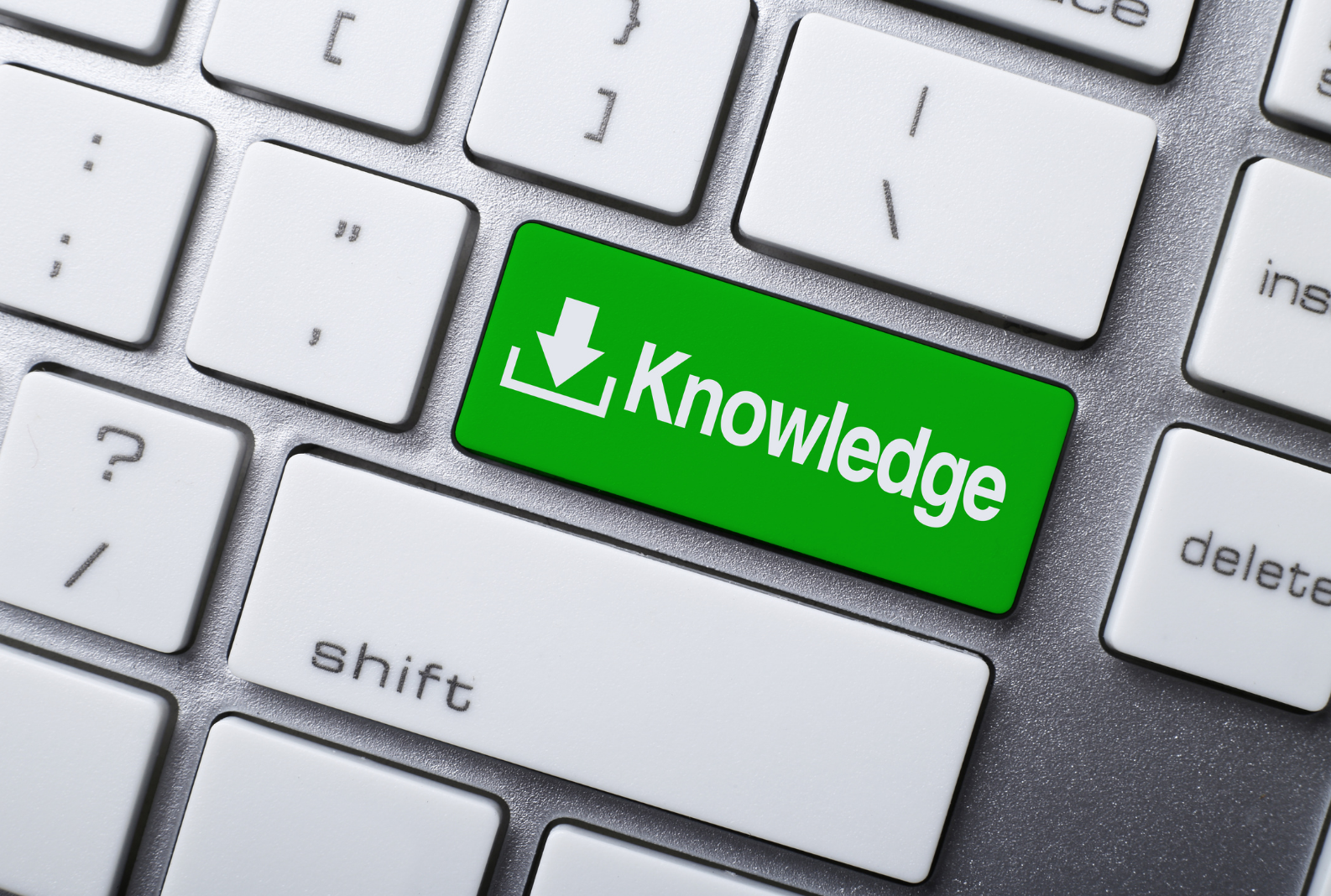 Green key reading 'Knowledge' on computer keyboard