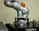 Impedance Control Self-Calibration of a Collaborative Robot Using Kinematic Coupling