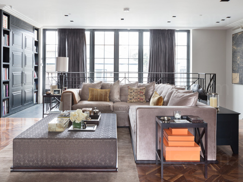 Classy and spacious living room with large cream corner sofa and decorative coffee table Zoom background