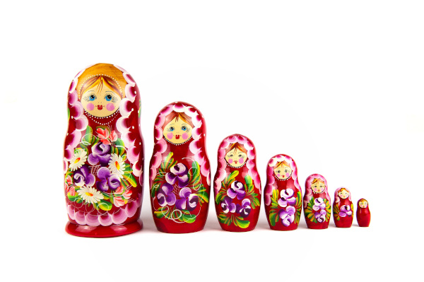 Seven, traditional wooden Russian Dolls doing from largerst on the left, to smallest on the right.