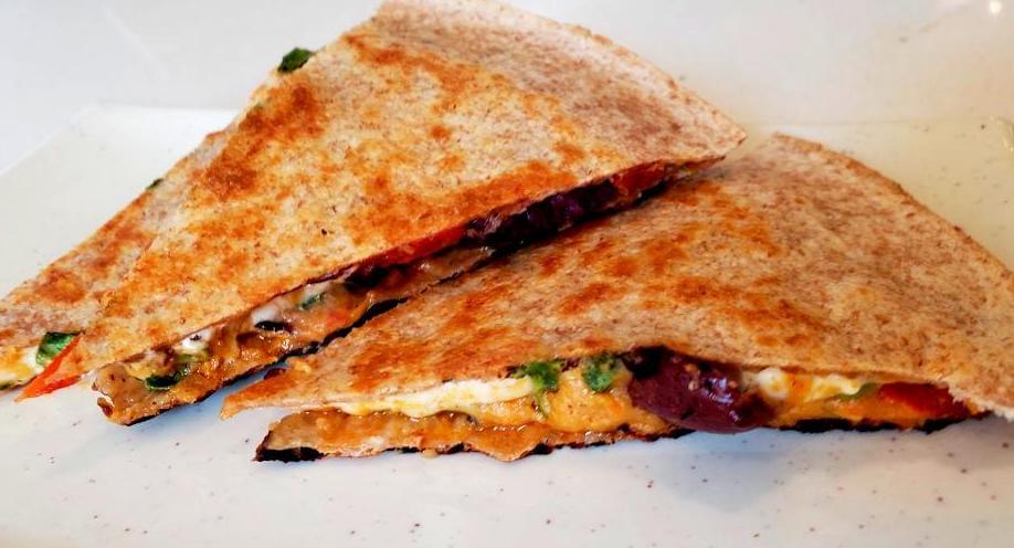 Plate with three slices of a roasted red pepper quesadilla