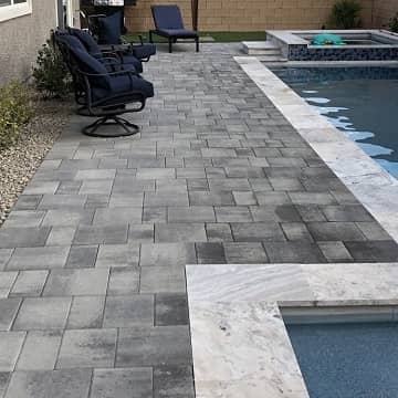 grey stone pavement next to a new pool installation