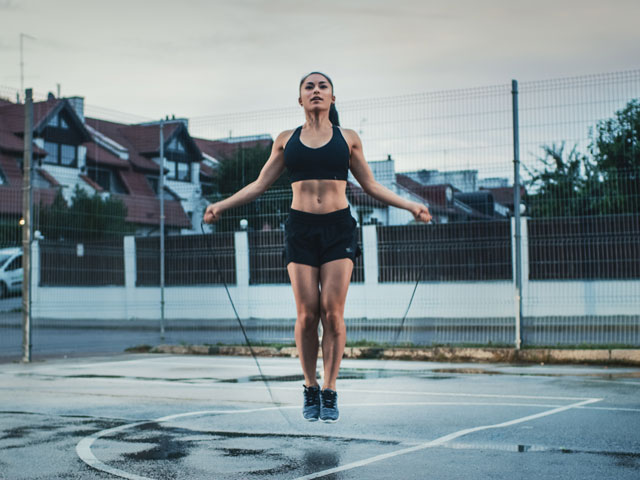 A woman doing jump rope exercises to exhaustion
