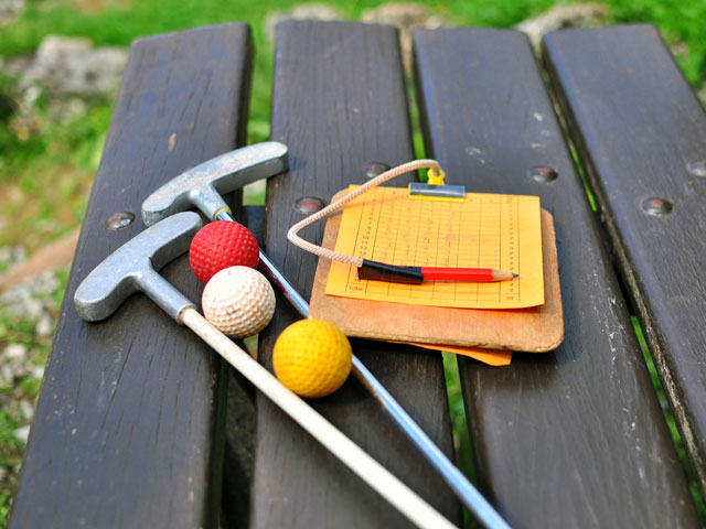 Everything you need to play a round of mini golf, balls, clubs and a scorecard