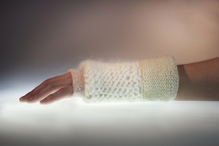 a human arm is encased in a cast made of white wool at three different weaves, for temperature control and structural soundness.