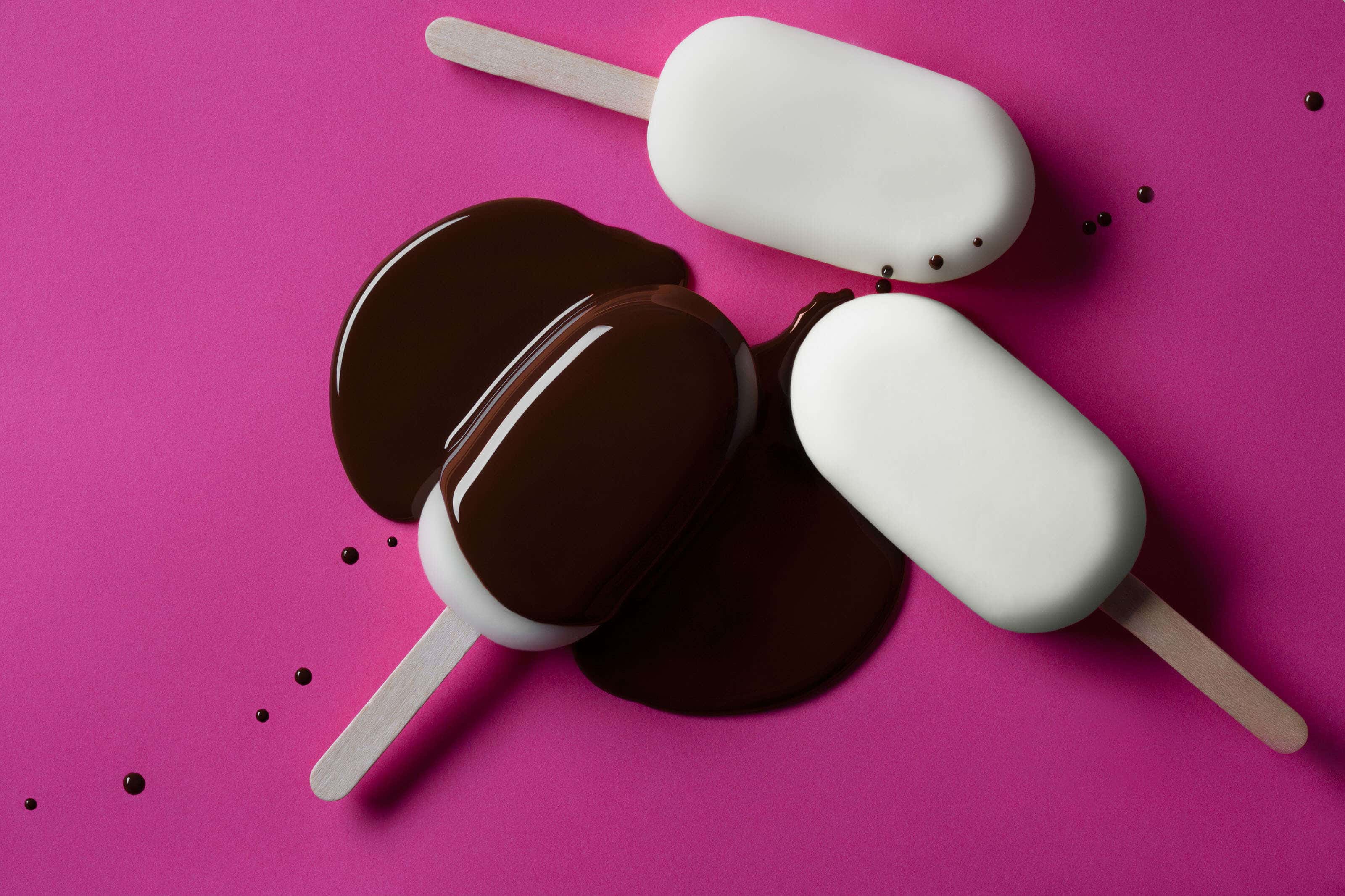 magnum ice cream lollies on pink background with chocolate poured over
