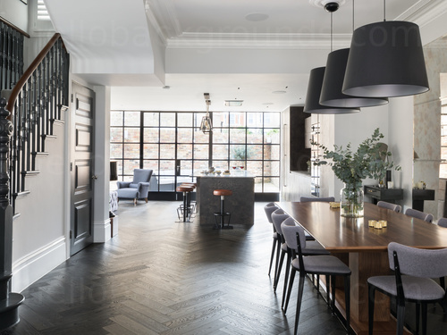 Large modern and simple open dining area decorated with pastel colours featuring a staircase and dining table Zoom background