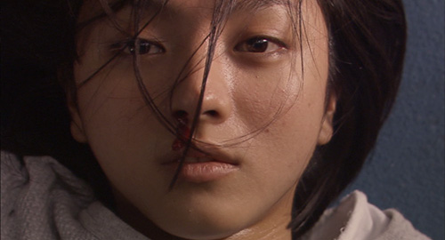 A close-up screenshot of Haru (played by Hikari Mitsushima). From the movie 'Kakera: A Piece of Our Life'.