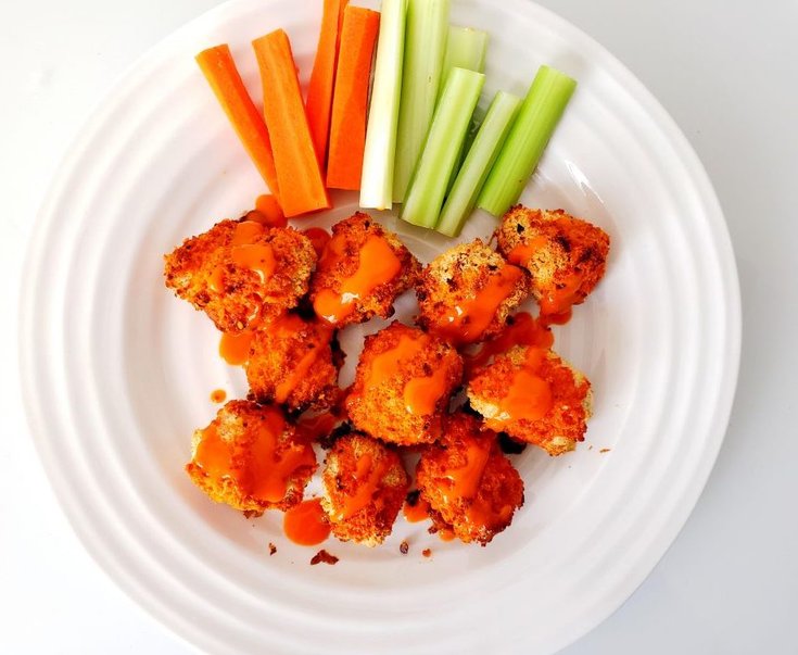 Plate of Cauliflower Wings Drizzled with Buffalo Sauce