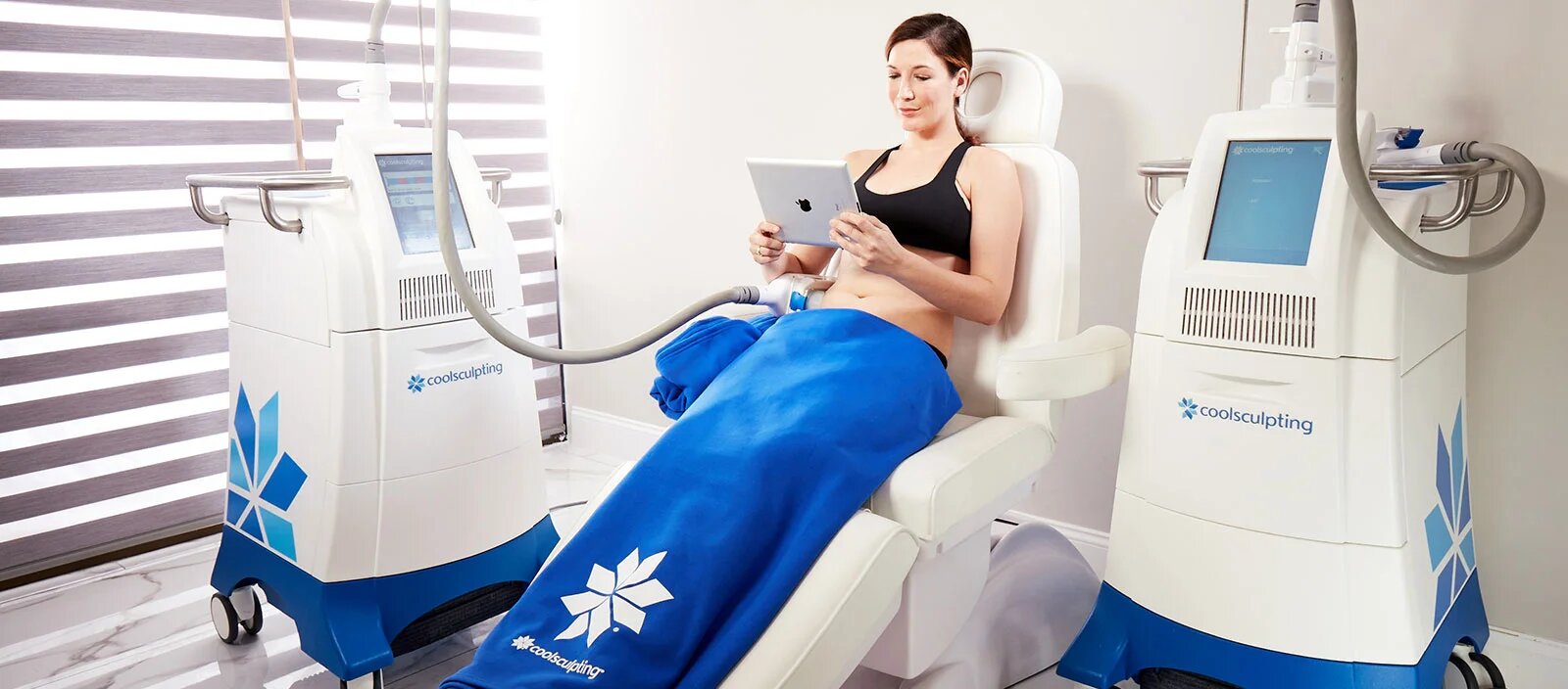 Woman sitting down and receiving CoolSculpting treatment