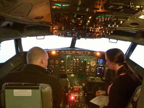Me sitting in a Boeing 737 flight simulator with a British Airways flight instructor.