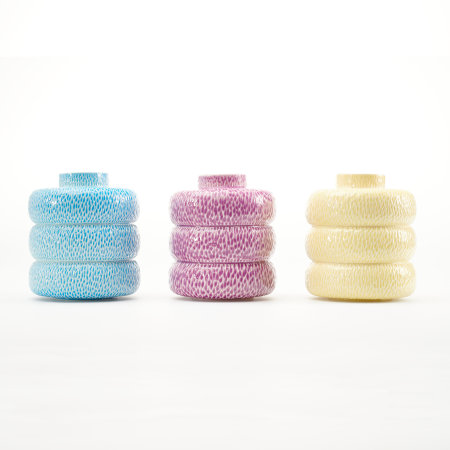 Three textured jars in different colours: blue, magenta-purple and yellow