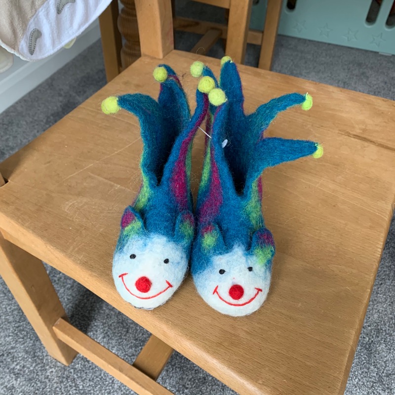 A nightmarish pair of felt jester shoes for a baby.