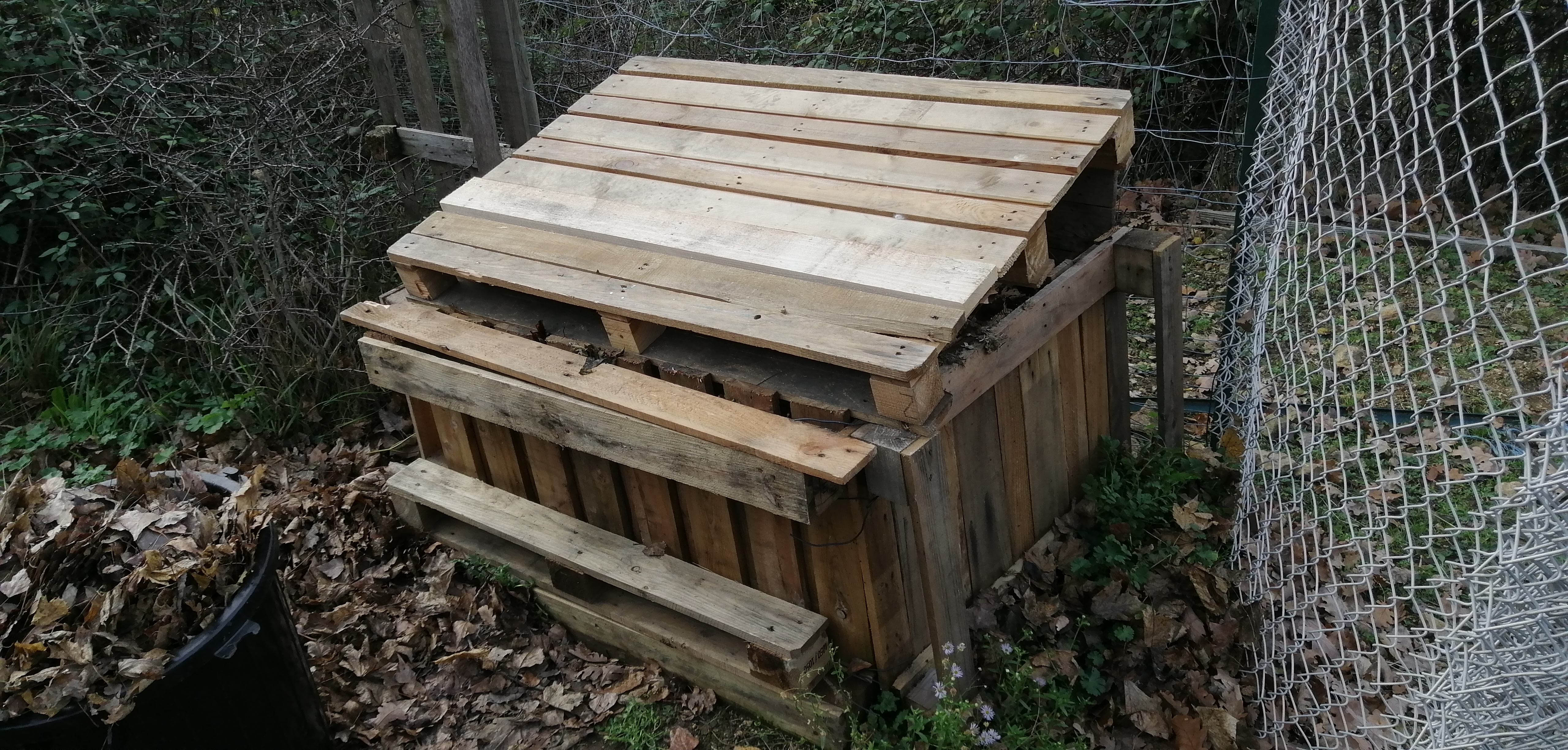 Full compost bin with top cover down