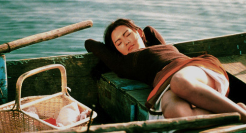 A screenshot from the film 'The Isle' of a woman casually sleeping in her canoe in the water.