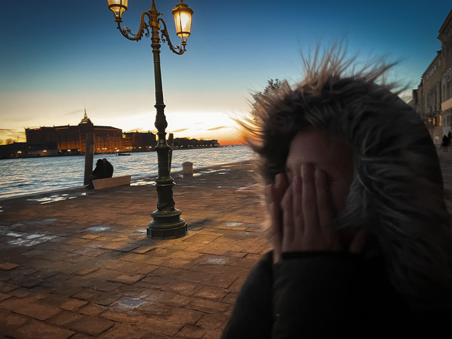 Foto i Chiara che si copre gli occhi con lo sfondo di un tramonto a Zattere