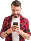A man in a checked shirt looking at his phone