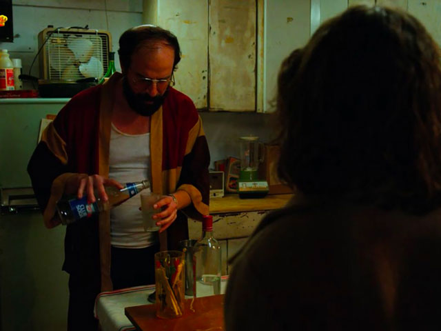 Murray pouring Vodka for he and Joyce to play the Stranger Things Drinking Game together