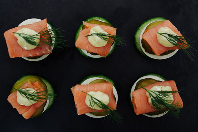 smoked salmon appetizers on a black background