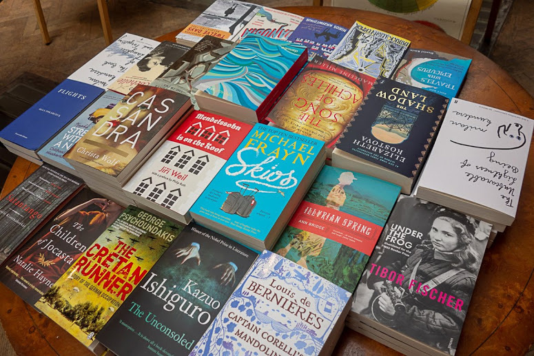 tabletop display of colorful books at Daunt Books in London