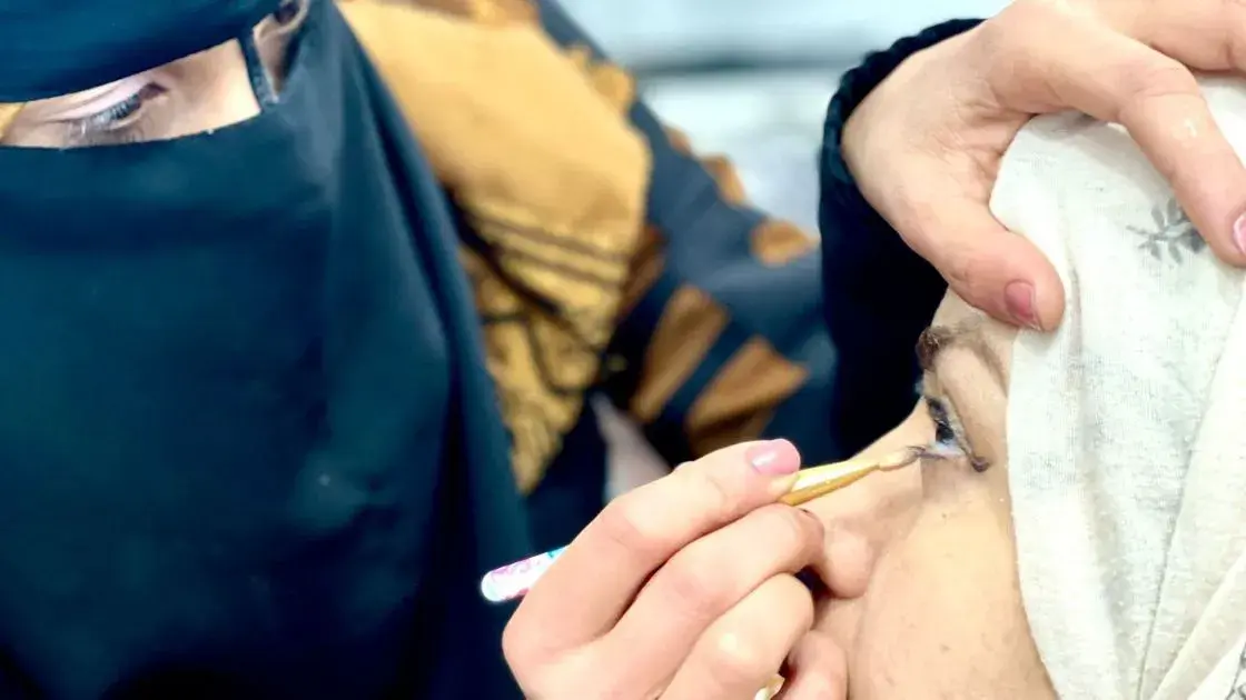 Syrian woman getting makeup applied