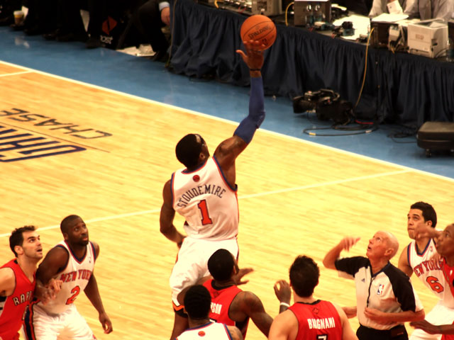 Amare Stoudamire of the New York Knicks wins the tipoff to start the game