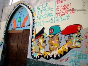 [This painting by Ammar Abo-Bakr of a massive SCAF-headed serpent lines the wall of the Lycee Francais.]