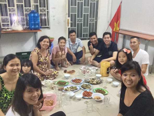 Vietnamese family eating dinner with men separate from the women