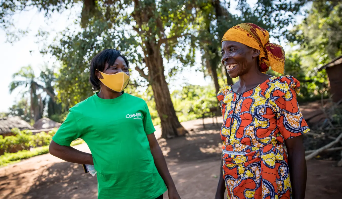 Adrenise Lusa, 60, speaks with Micheline Kayiba, programme manager of Concern Worldwide’s graduation programme in the village of Kaiha, Manono Territory.