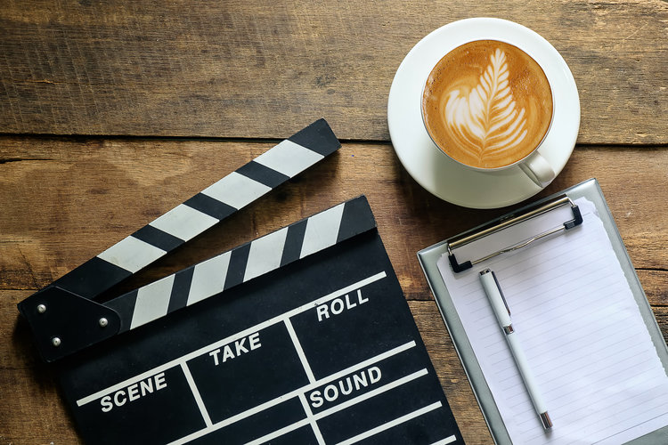 clapper with coffee cup and notepad