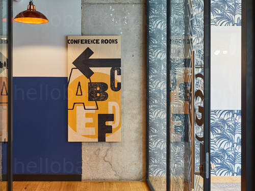 Artistic style shared workspace with multi-patterned wall design and retro style hanging lamp shade with warm light Zoom background