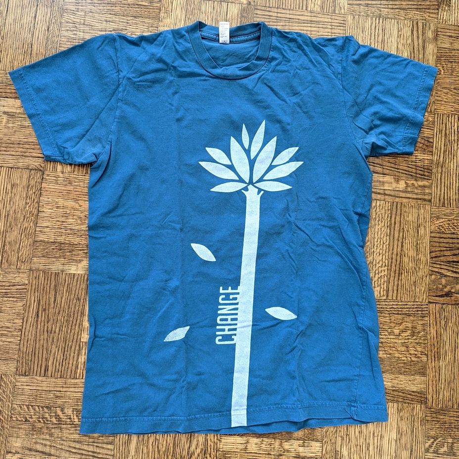Front view of a blue T-shirt that reads “Change”